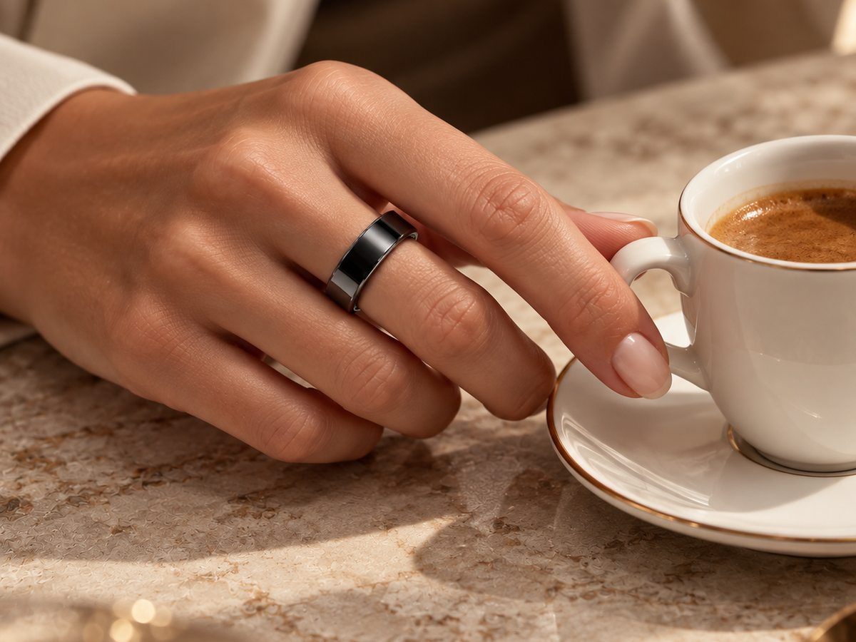 Moonphase Smart Ring in black with a cup of coffee