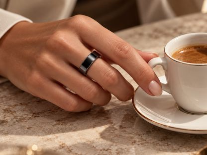 Moonphase Smart Ring in black with a cup of coffee